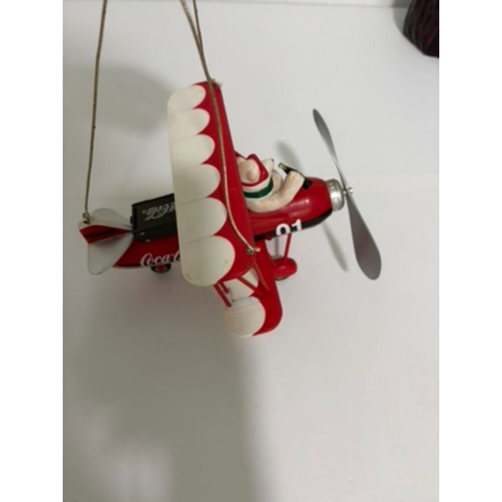 Vtg. Coca cola christmas decoration featuring a polar bear in a red biplane